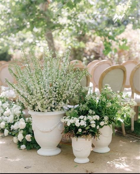 Outdoor Ceremony Decor With White Vases And Flowers