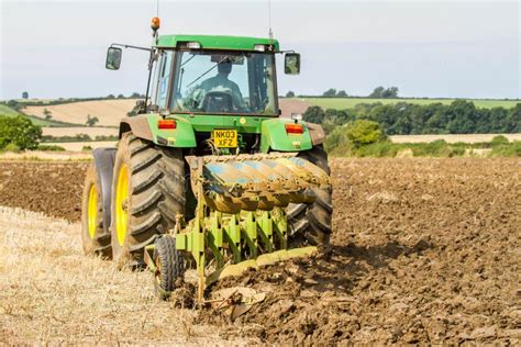 Modern John Deere Tractor Pulling A Plough Editorial Stock Photo