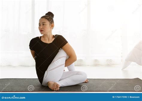 Asian Women Doing Yoga Seated Twisting Exercise At Home Sitting In