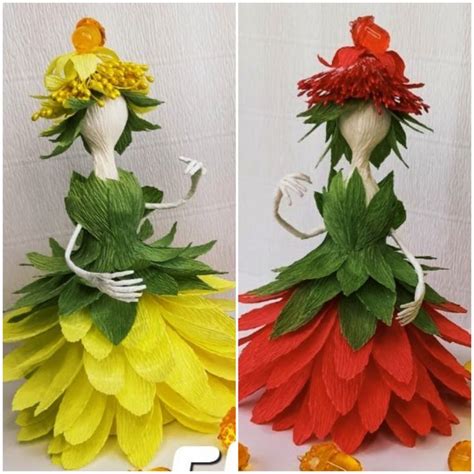 Two Paper Dolls Made To Look Like Flowers