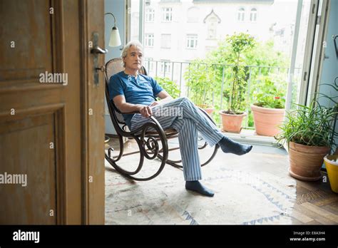 Mature Man Sitting In Rocking Chair Stock Photo Alamy