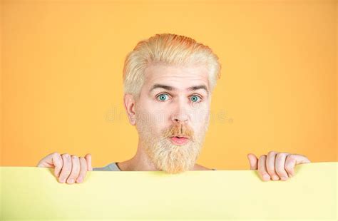 Man Holding A Blank Billboard Isolated On Yellow Background Stock