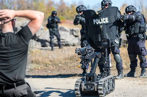 Police Swat Team Officers Using A Mechanical Robot Unit Stock Photo