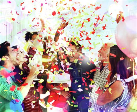 family throwing confetti celebrating birthday party  cake stock