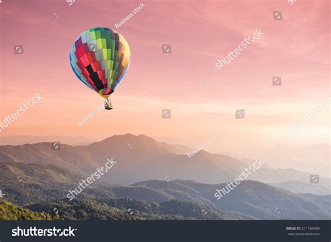 Hot Air Balloon Over High Mountain At Sunset Stock Photo