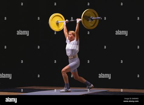 Female Olympic Style Weightlifter In Action Stock Photo Alamy