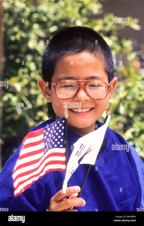 Young Korean-American boy poses with American and Korean flags Stock ...