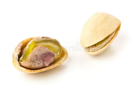 Macro Of Single Salted Roasted Green Pistachio Nut Over White