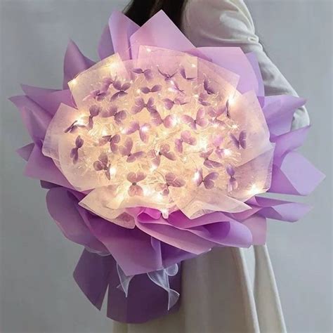 A Woman Holding A Lighted Purple Flower Bouquet