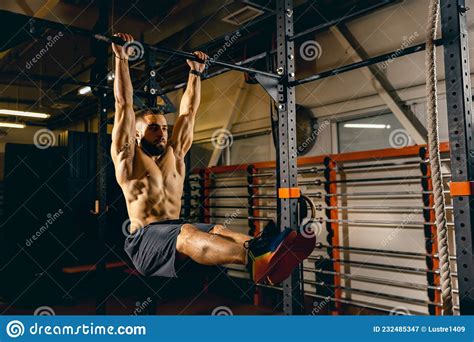 Portrait Of Sportive Man Doing Pull Up Exercises Developing Muscles