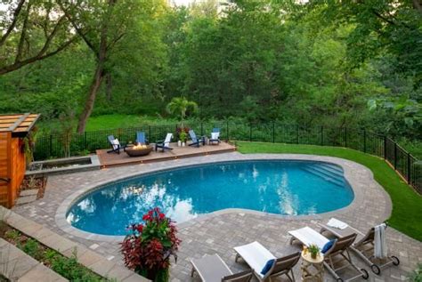 Lush Grasses And Purple Blooms Create A Sculptural Garden Pool