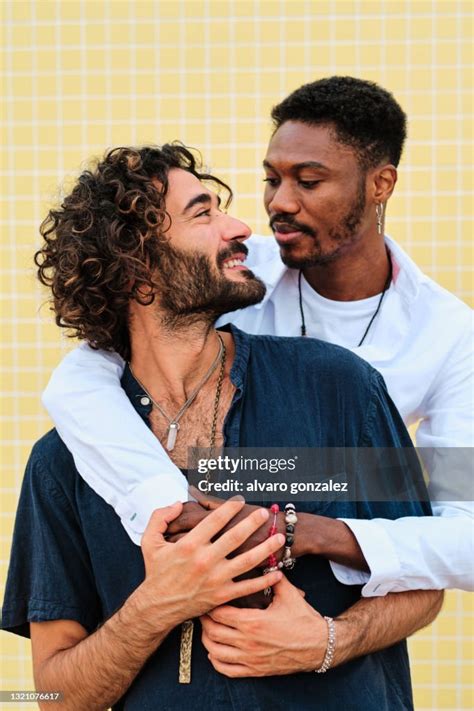 Close Up Of Young Interracial Gay Couple With Yellow Background High