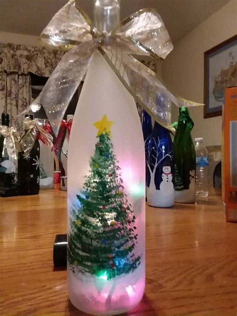 A Lighted Bottle With A Christmas Tree On It