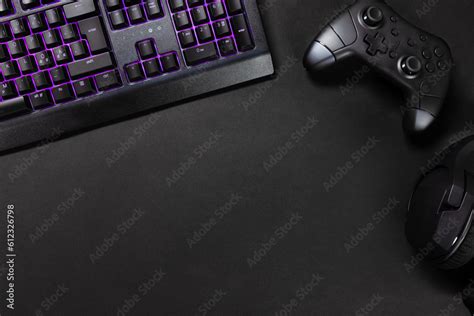 Purple lit keyboard by game controller and mouse Stock Photo | Adobe Stock