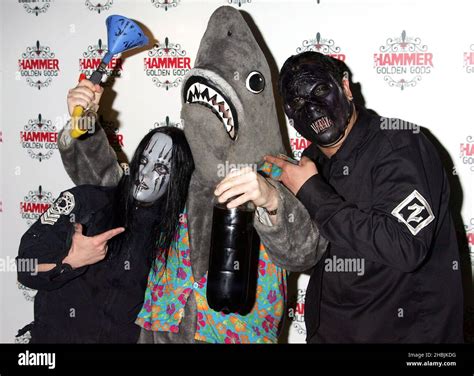 Joey Richardson And Paul Gray Of Slipknot Pose With Shark At Arrivals