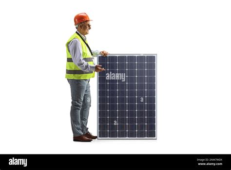 Mature Male Engineer With A Vest And Hardhat Standing Next To A