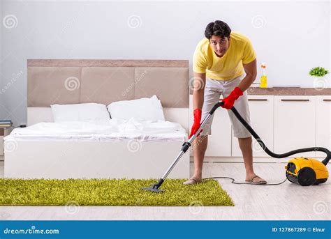 The Young Handsome Man Cleaning In The Bedroom Stock Image Image Of