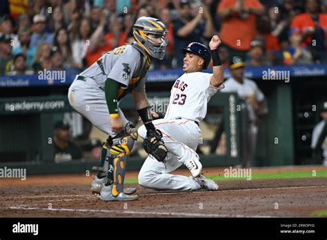 Houston Astros Designated Hitter Michael Brantley Slides Safe Into