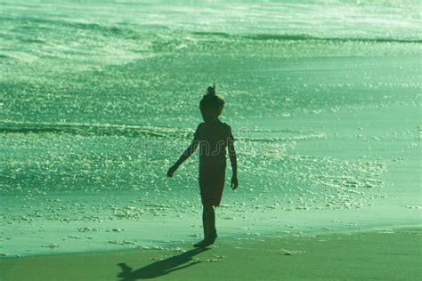 Silhouette Of Walking Girl On Beach At Sunset Picture. Image: 5754539