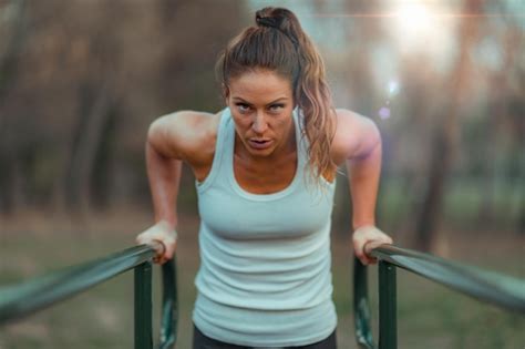 Premium Photo Exercising On Parallel Bar Outdoor Gym