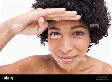 Smiling Brunette Precisely Looking Ahead With Her Hand Above Her Eyes Stock Photo Alamy