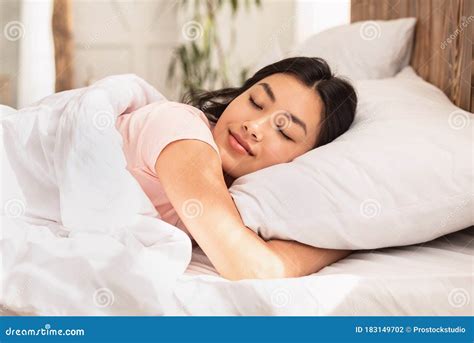 Asian Woman Sleeping Lying In Bed At Home Hugging Pillow Stock Photo