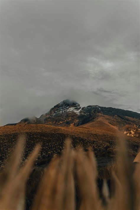 Snow On Rock Mountain Peak Over Meadow · Free Stock Photo