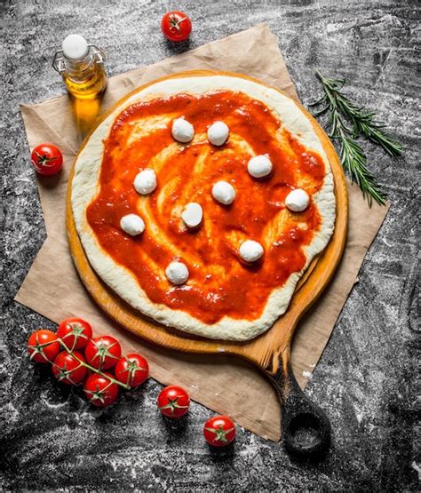 Premium Photo Raw Pizza Rolled Out Dough With Mozzarella And Tomato Paste