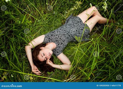 Brunette Woman Lying On Green Grass Stock Photo Image Of Cheerful