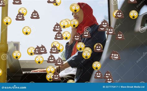 Animation Of Od Falling Emojis Over Woman In Hijab Using Smartphone