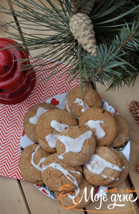 Ginger Cookies With Icing On A Plate Next To Pine Cones