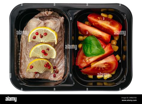 Baked Fish With Sauce And Side Dish In Lunch Box On White Backgr Stock