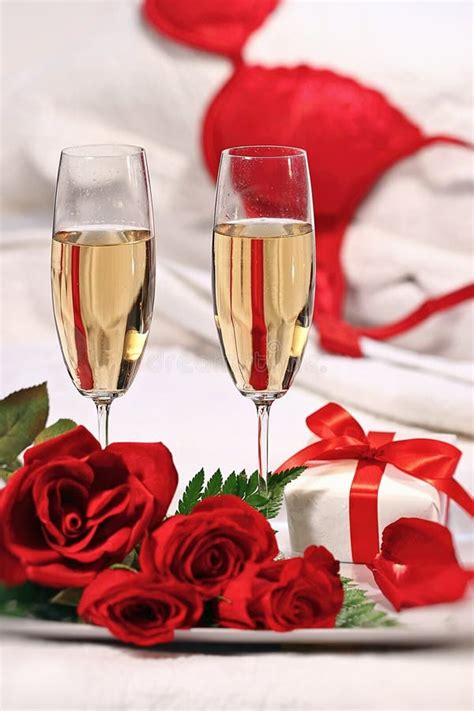 Champagne Glasses And Roses To Celebrate Valentines Stock Photo