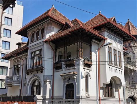 An Old Building With Many Windows And Balconies On The Top Floor Is Shown