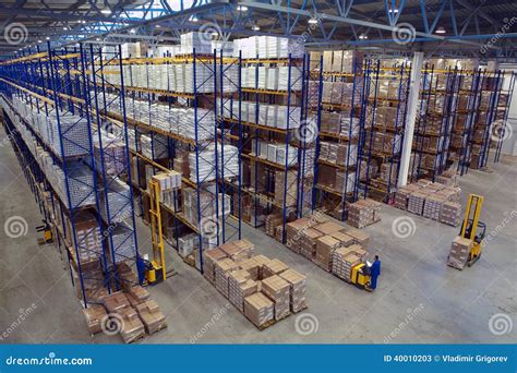 Interior Large Warehouse With Freight Stacked High. Editorial Stock