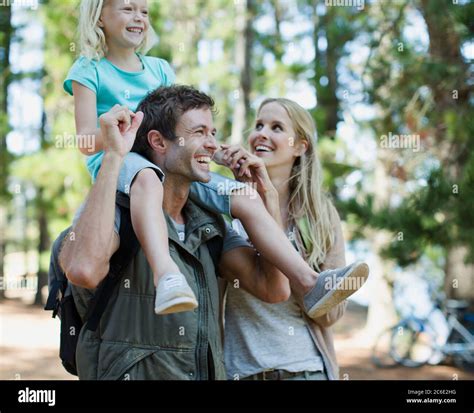 Father Carrying Daughter On Shoulders In Woods Stock Photo Alamy