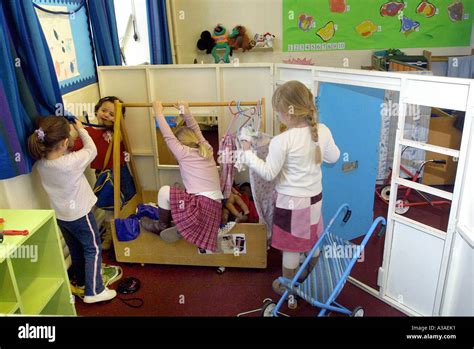 Nursery School Children In Home Corner Play Acting Stock Photo Alamy