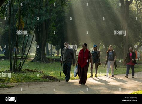 Dhaka residents take a morning walk in the wintry weather in the Ramna ...