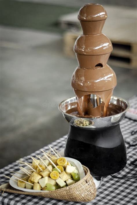 Chocolate Fountain Catering Machine With Fruit Skewers On Buffet Table