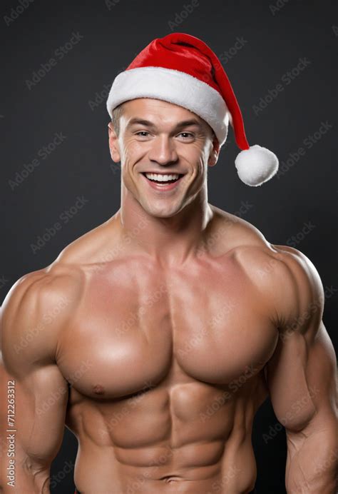 Joyful Buff Bodybuilder In Santa Hat Cheeky Attractive Nude Santa Claus Striking Pose Against