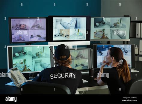 Security Guards Monitoring Modern Cctv Cameras In Surveillance Room