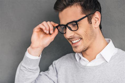 Elegance And Success Side View Of Confident Young Man Adjusting His Glasses And Looking Away