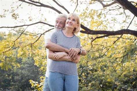 Senior Couples Stand To Hug Each Other And Smile Happily Stock Image