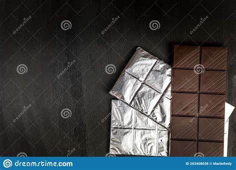 Chocolate Ba On Black Wooden Background Top View Chocolate Wrapped In