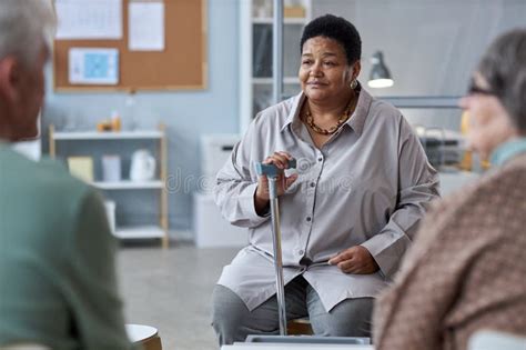 Senior Black Woman Sitting In Circle At Mental Health Support Group