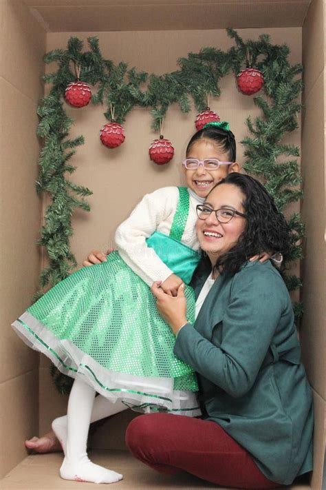 Mom With Her Year Old Brunette Daughter With Eyeglasses Inside A Decorated Gift Box To