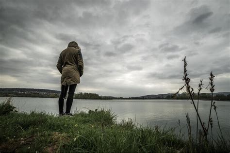 Premium Photo Rear View Of Woman Standing At Lakeshore Against Sky