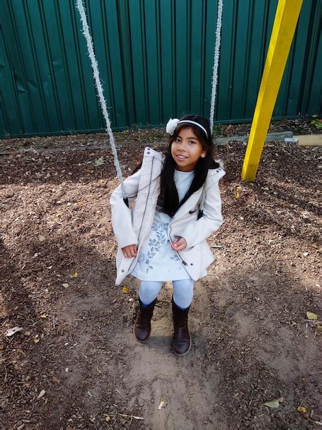 Premium Photo Portrait Of Girl Sitting On Swing