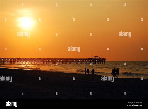 People Stroll Myrtle Beach S Grand Strand And Greet The Sunrise Along