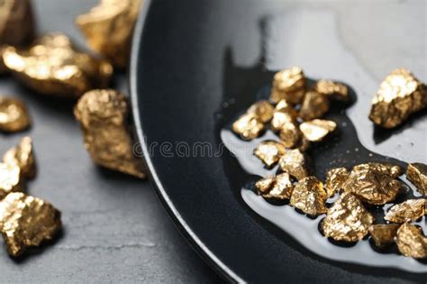 Plate With Gold Nuggets On Black Table Closeup Stock Photo Image Of
